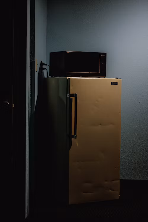 A compact mini-fridge on its own against a plain background